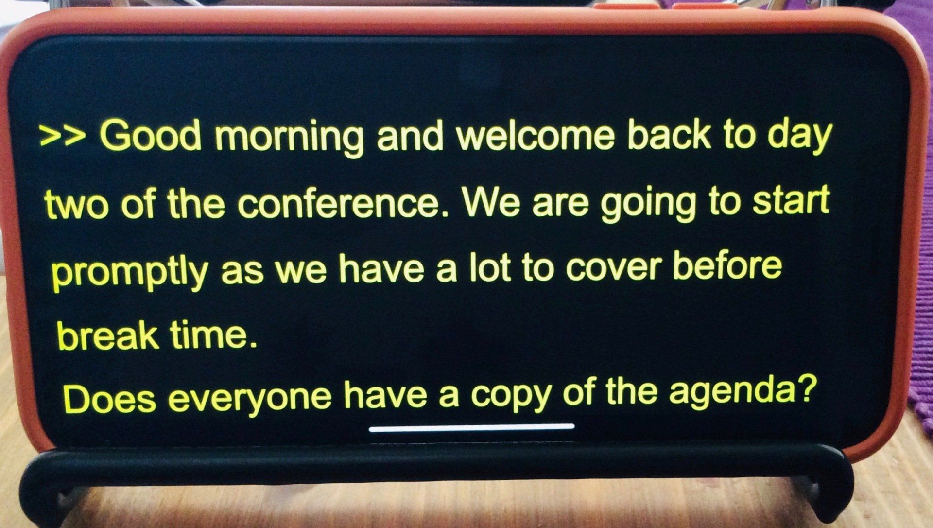 Mobile phone displaying full screen yellow captions on black background. Mobile phone displaying full screen yellow captions on black background.