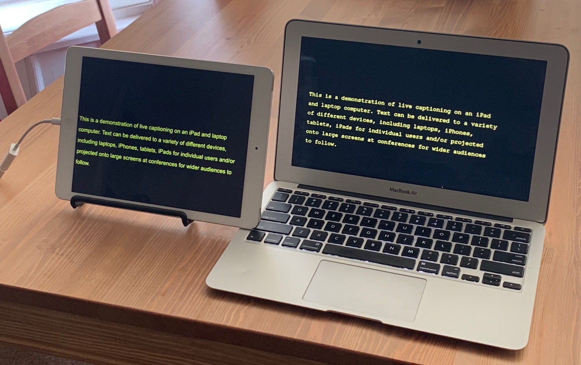 iPad and laptop with yellow text and black background.