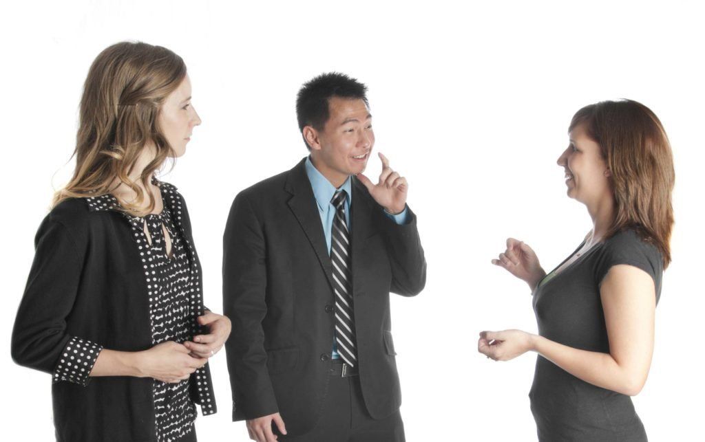 Woman watching a male lipspeaker relay doctor's message. Woman watching a male lipspeaker relay doctor's message.