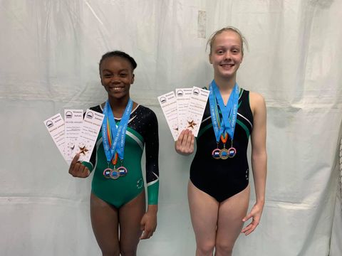 Gymnasts with medals smiling after their competition