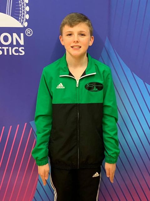 A gymnast smiling after their competition