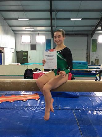 Gymnast passing her grades with distinction