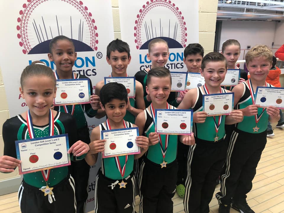 Gymnast wearing medals, smiling and celebrating after a competition