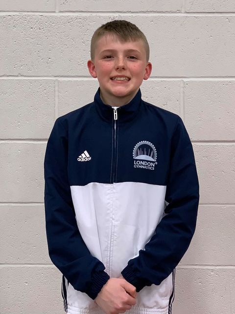 A london gymnast smiling after their competition