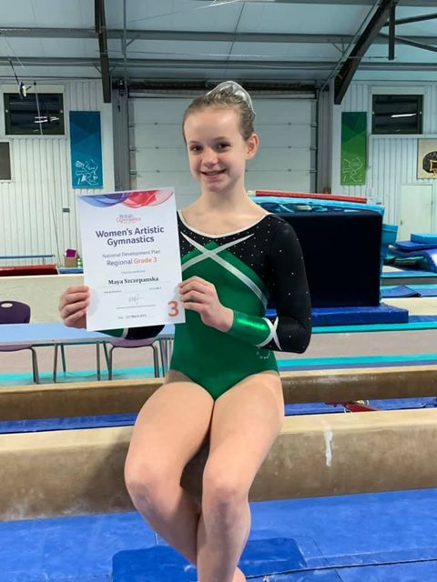 Gymnast sat on the beam after a competition