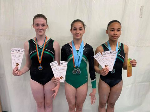 Gymnasts with medals smiling after their competition