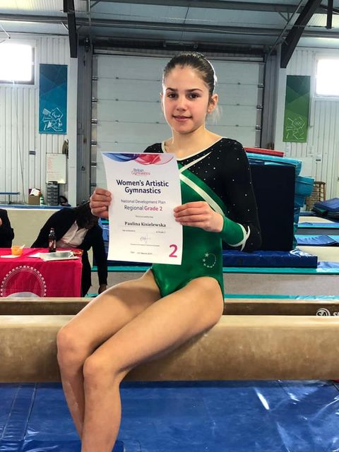 Gymnasts sat on the beam after a competition