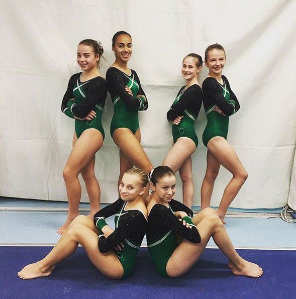 Competition Squads. Artistic gymnasts having fun together at a competition