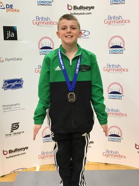 gymnast at the london open competition with a silver medal