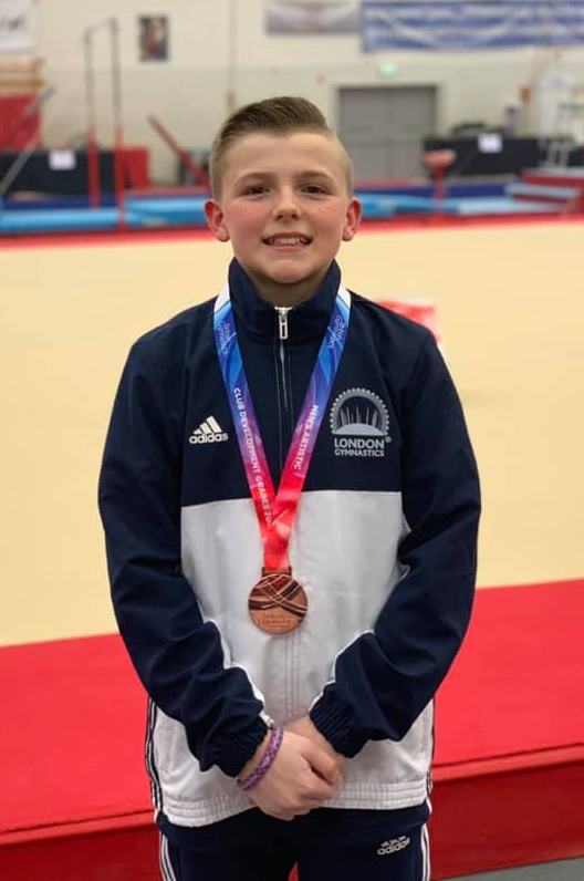 gymnast with medal after competition