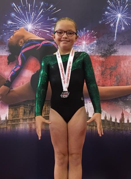 Gymnast with a medal at the codebreakers competition