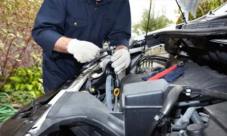 Engineer completing roadside repairs on a vehicle