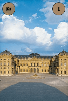 Ein großes Gebäude mit blauem Himmel und Wolken im Hintergrund