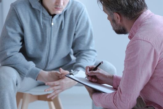 Psychologist interviewing his depressed patient during a therapy
