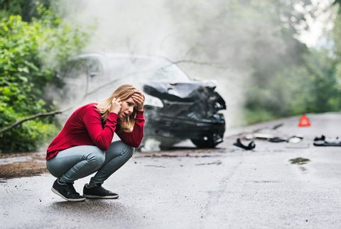 Immigration Attorney — Woman Making A Phone Call By The Damaged Car in Salem, OR Immigration Attorney — Woman Making A Phone Call By The Damaged Car in Salem, OR