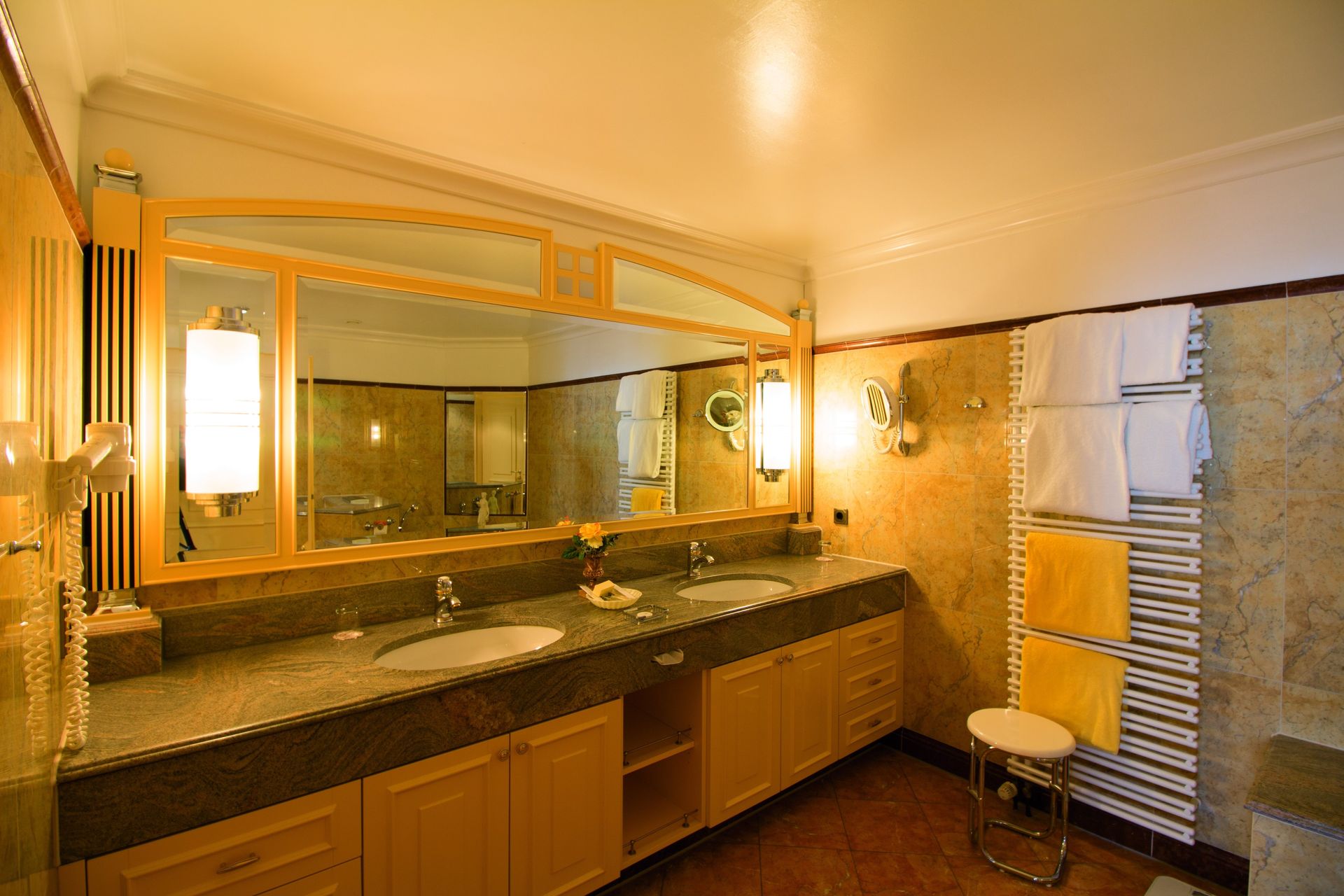 A bathroom with two sinks and a large mirror.