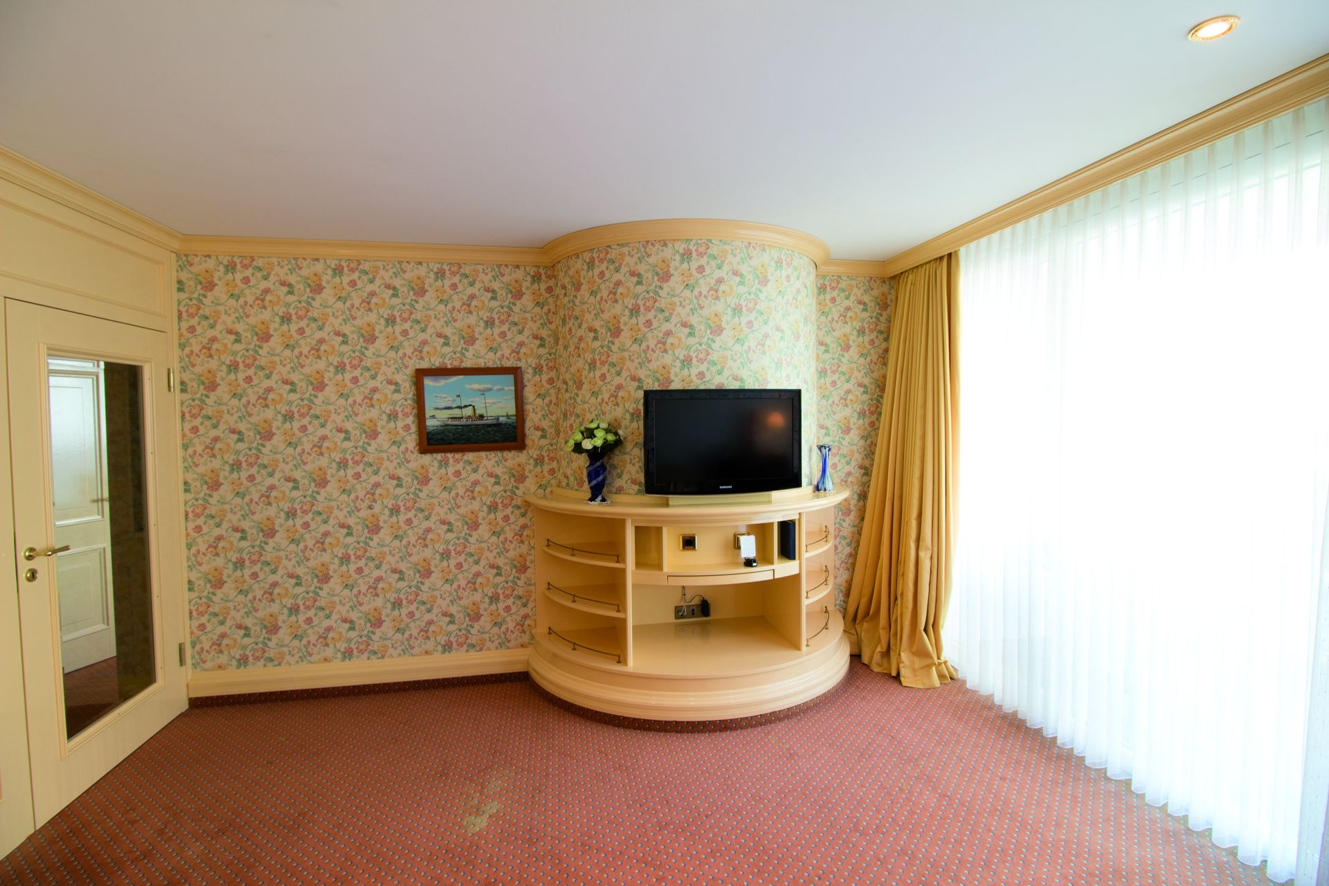 A living room with a flat screen tv on a stand