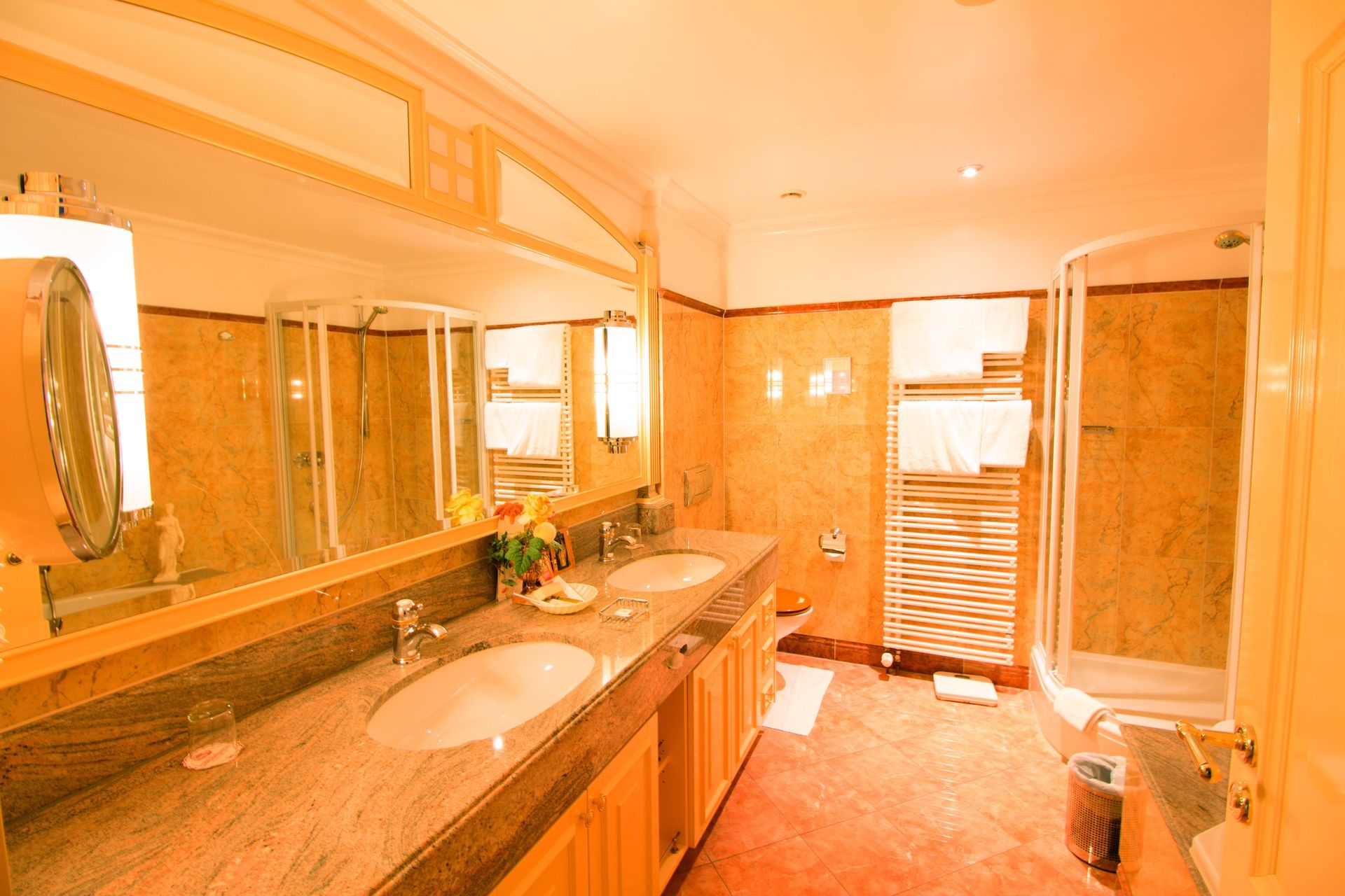 A bathroom with two sinks , a shower and a mirror.