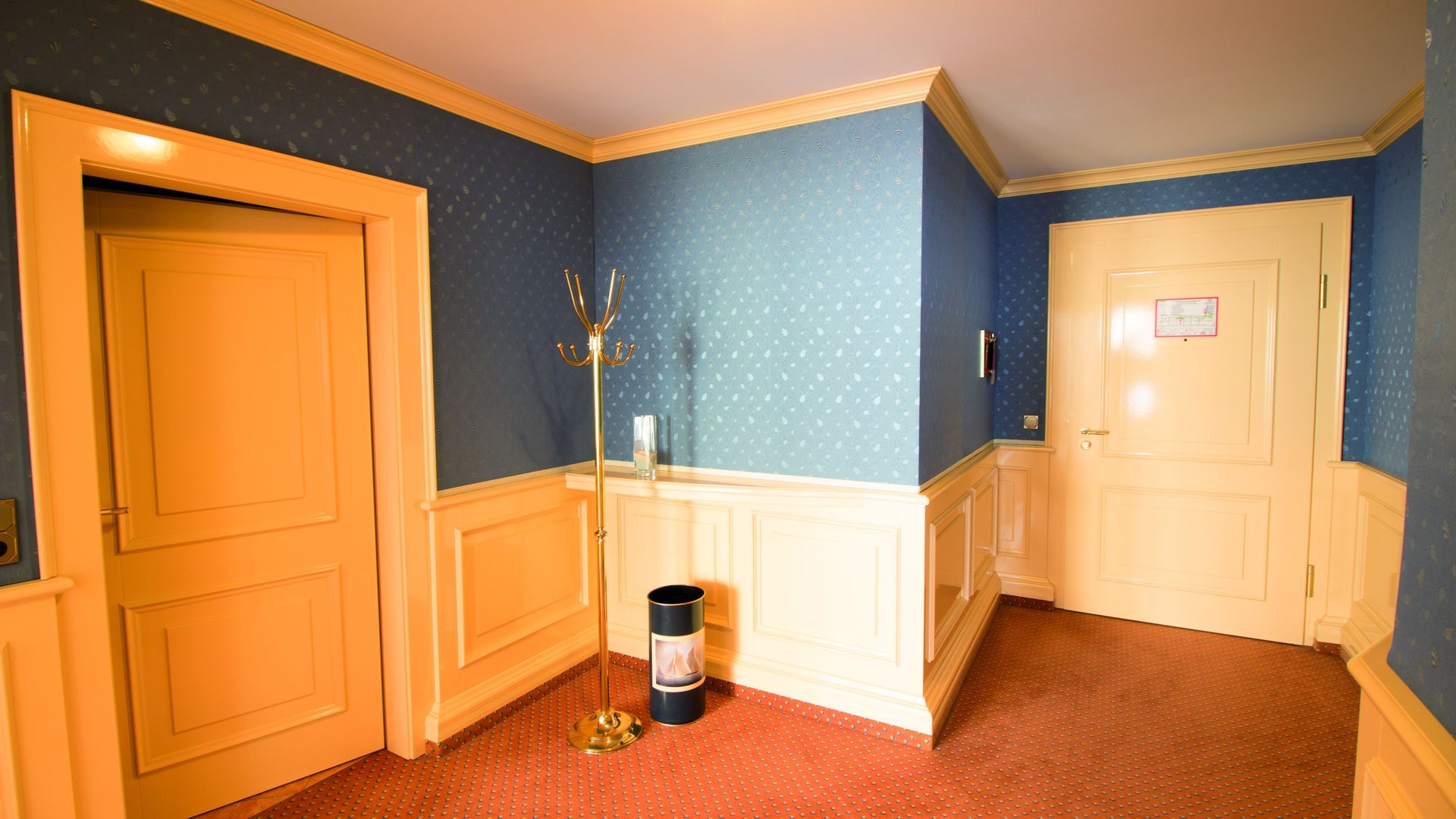 A hallway with yellow doors and blue walls