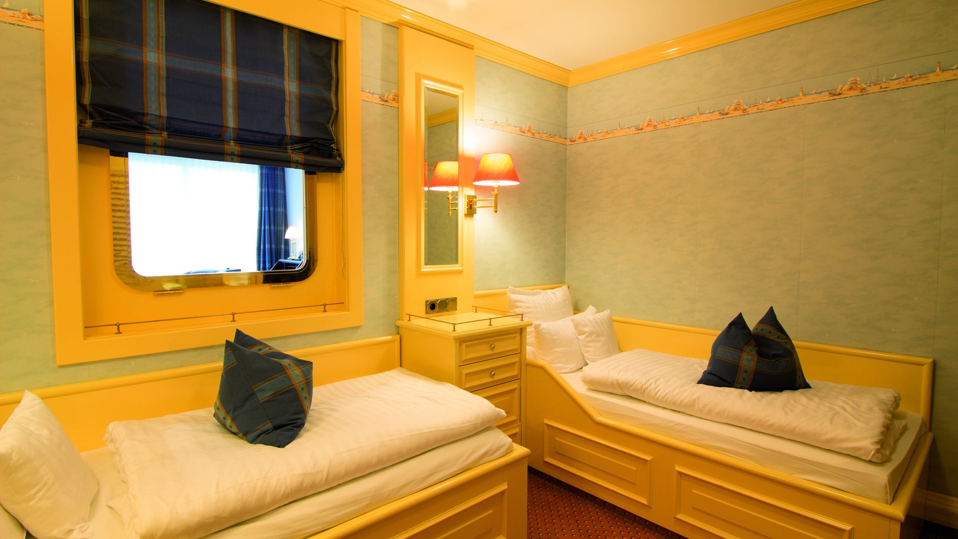 A hotel room with two beds and a window