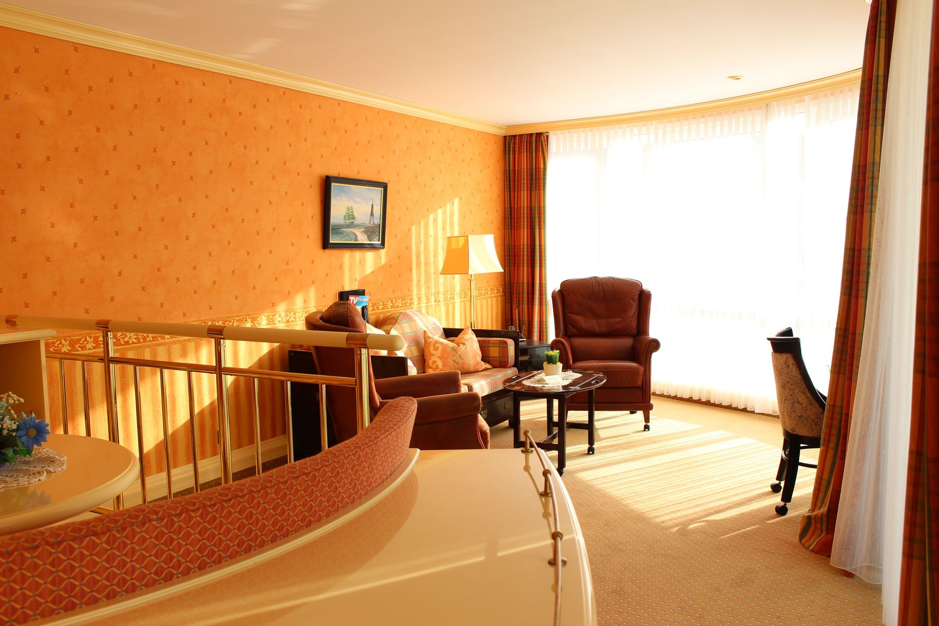 A living room with a staircase leading to the second floor