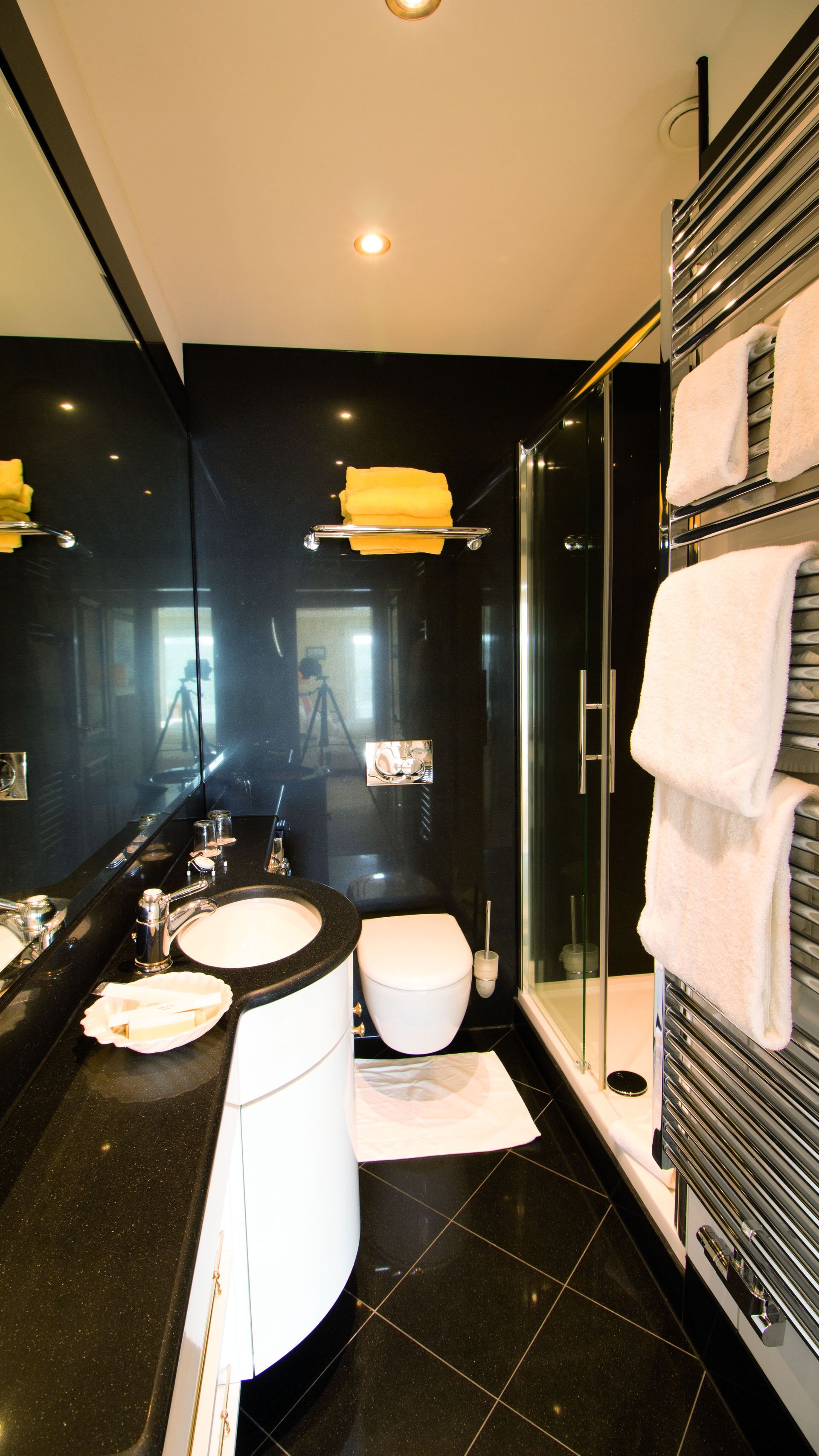 A bathroom with a toilet , sink , and shower.