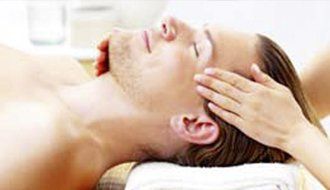 A man is getting a head massage at a spa.