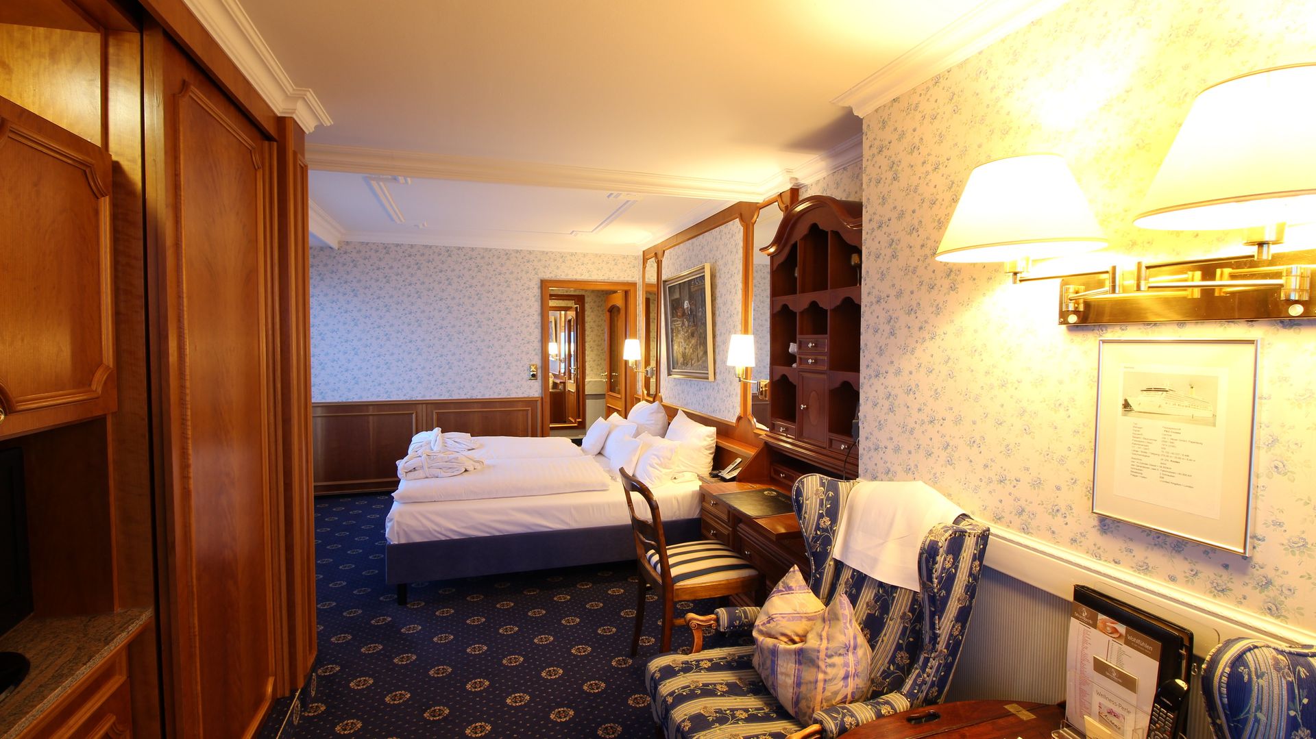 A hotel room with two beds and a chair