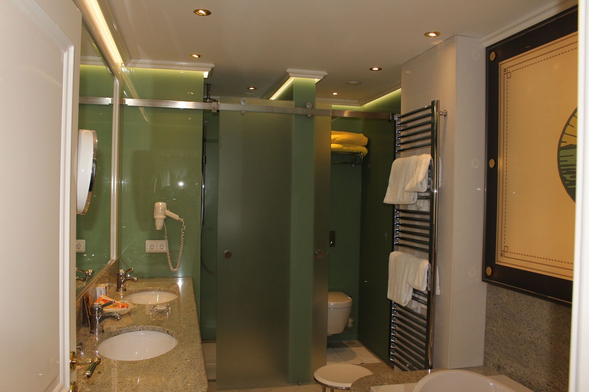 A bathroom with two sinks a toilet and a bathtub