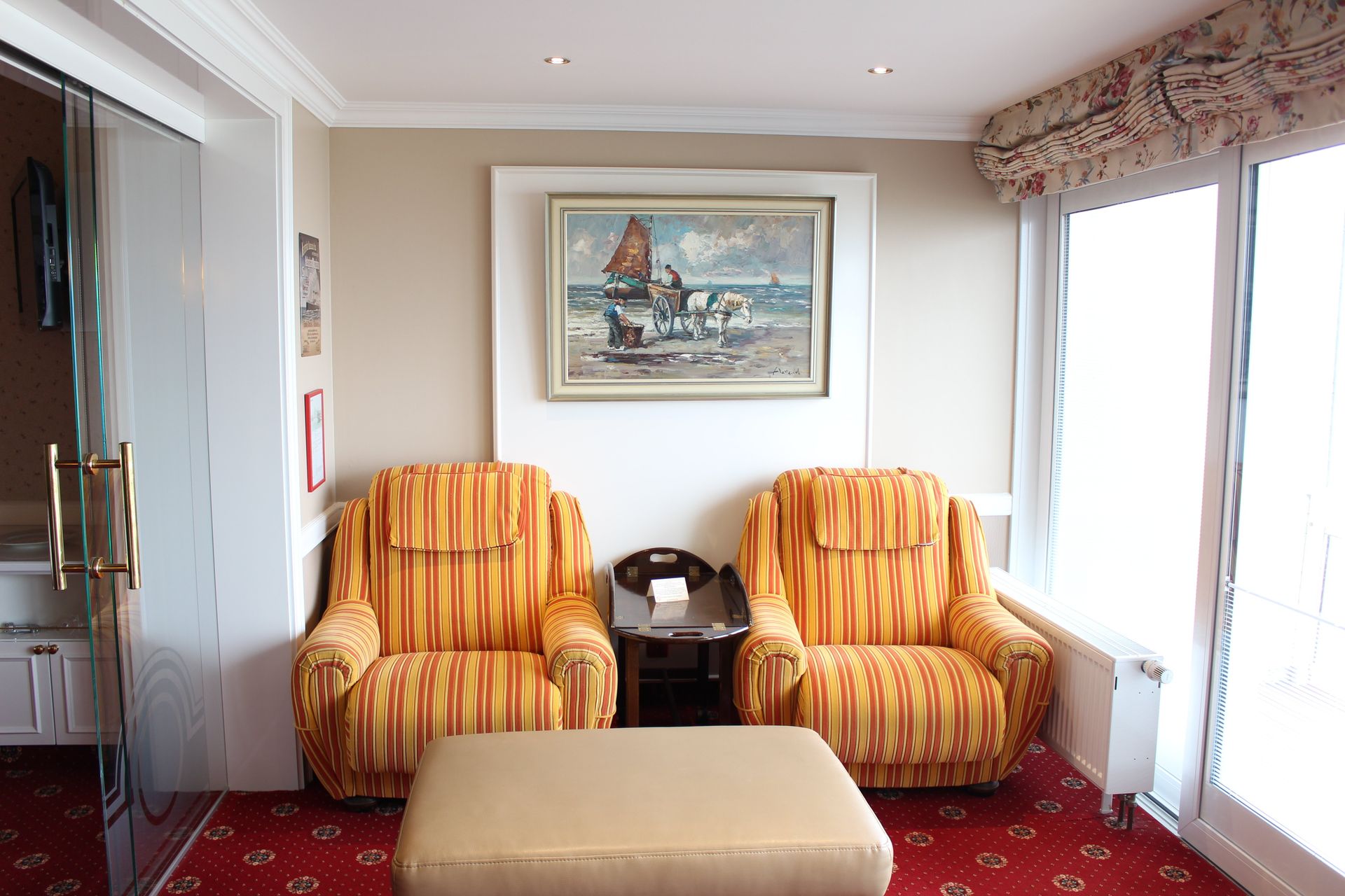 A living room with two chairs and a painting on the wall