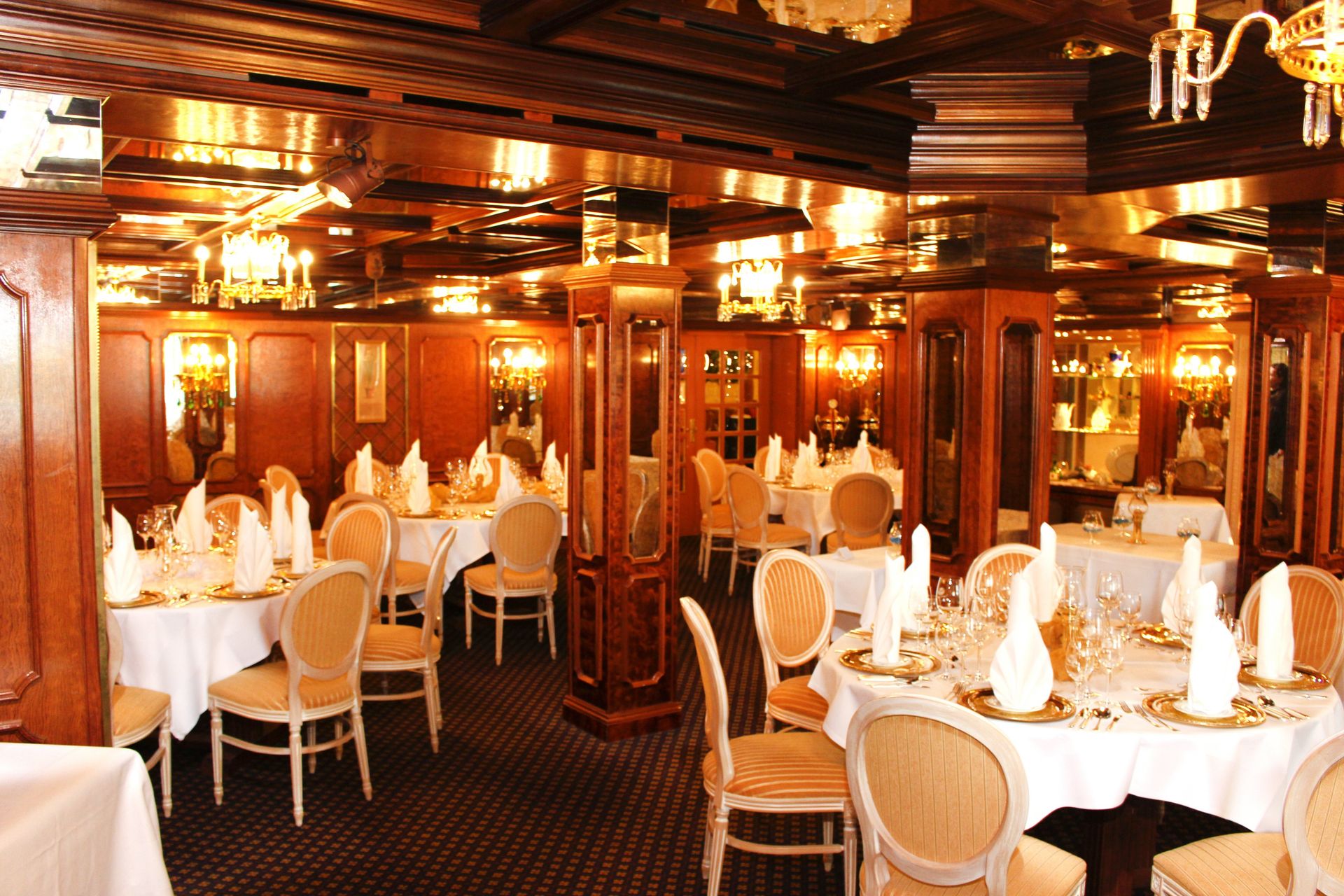 A large room with tables and chairs set up for a banquet