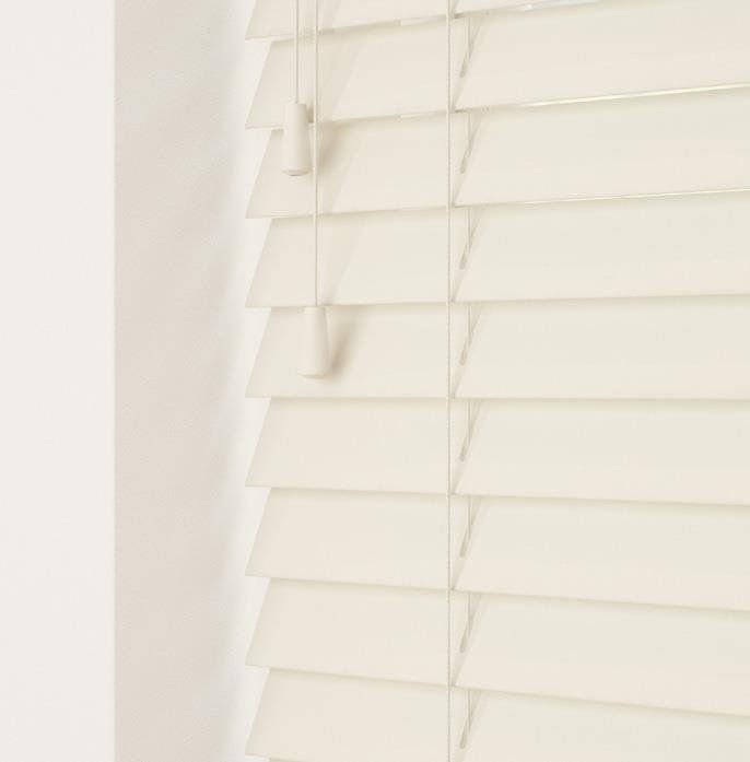 A close up of a white wooden blind on a window.