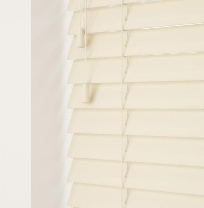 A close up of a white wooden blind on a window.