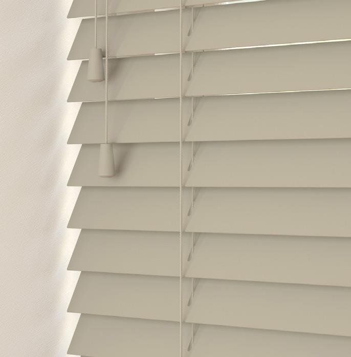 A close up of a white wooden blind on a window.