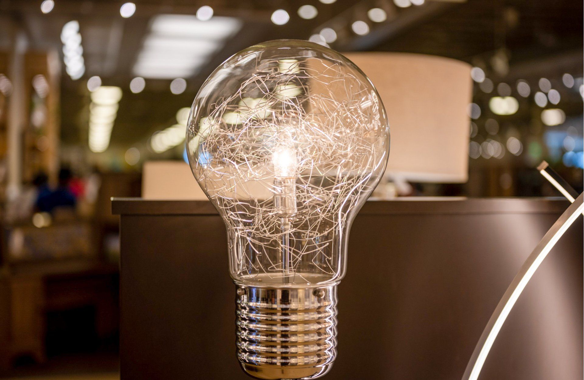 a light bulb is sitting on top of a table in a store .