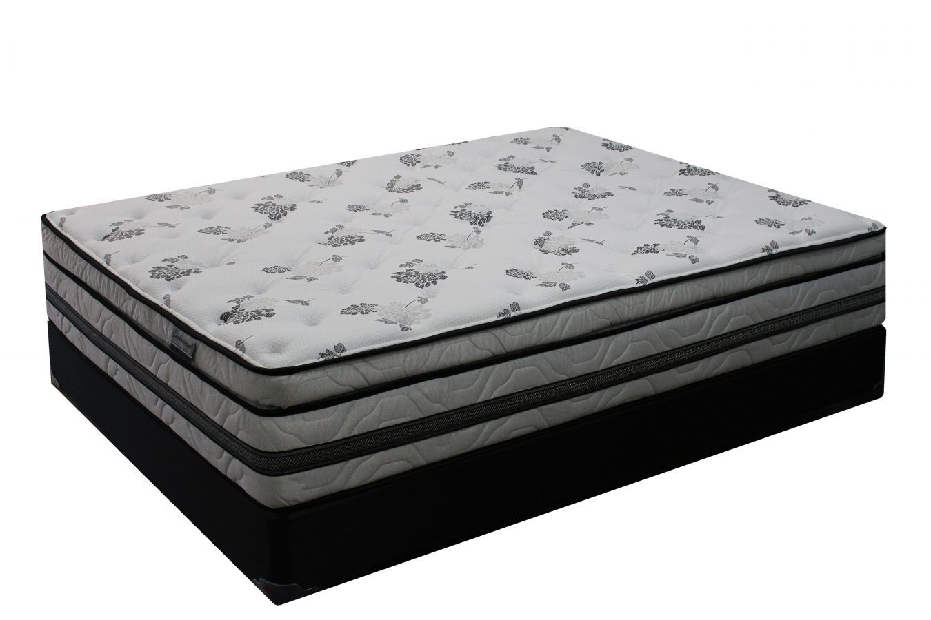 A mattress with a white patterned top and grey sides, set on a solid black foundation against a white background.