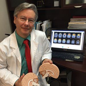 Dr. McAlister Holding Brain Replica —  East Brunswick, NJ — Integrative Neurotherapy