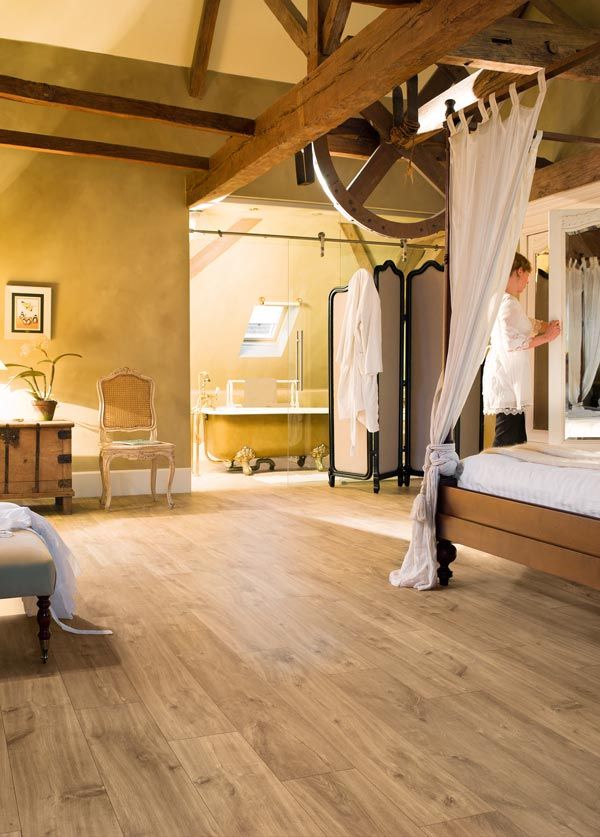 bedroom with yellow walls and big beams with new timber floor