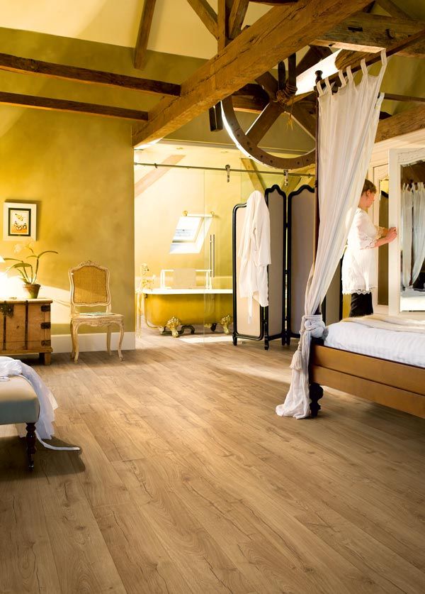 bedroom with yellow walls and laminate wood floors