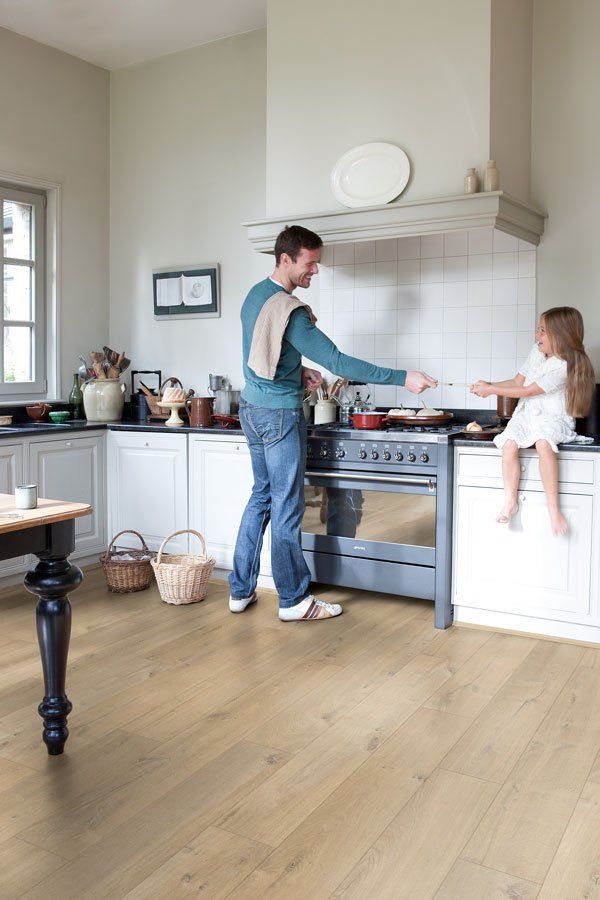 father and daughter in kitchen cooking