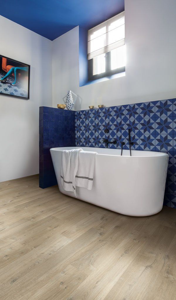 blue and white bathroom with laminate wood floor