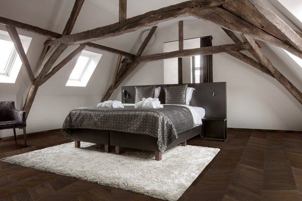 loft bedroom with dark timber floor