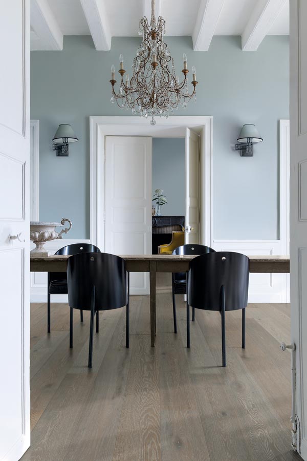 dining room with light blue walls and grey toned timber