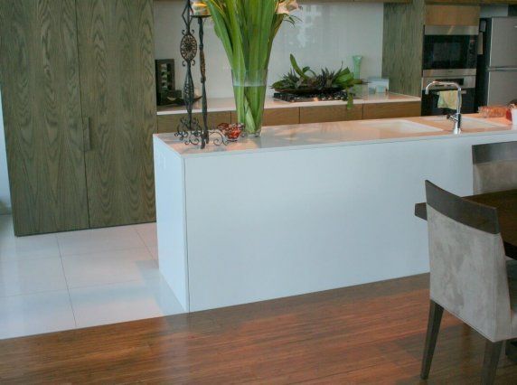 wood flooring next to white tile