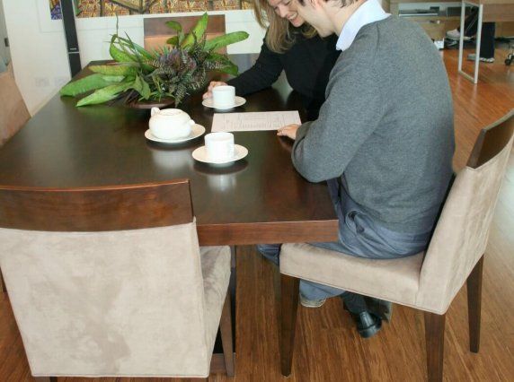 people chatting at desk on wood flooring