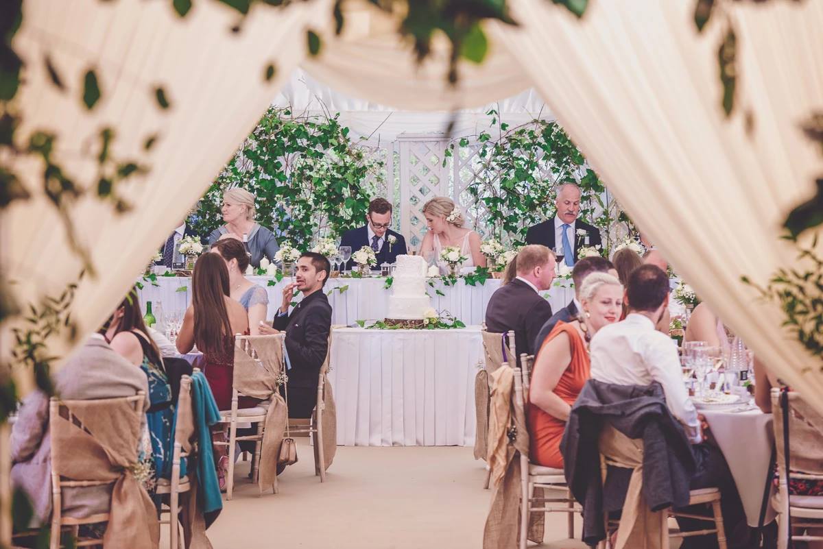 A group of people are sitting at tables at a wedding reception.
