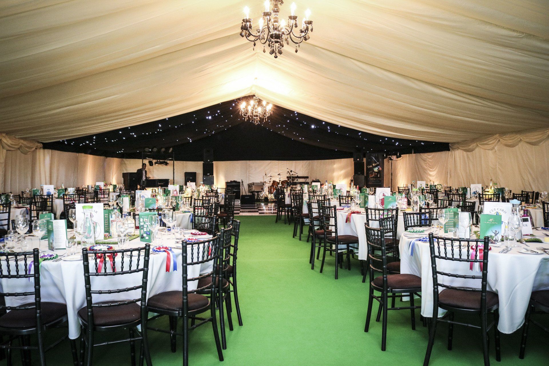A large tent with tables and chairs set up for a party.
