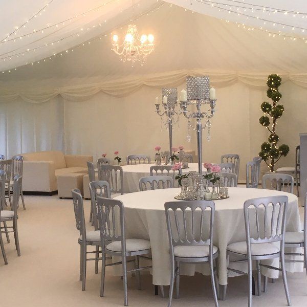 A large room with tables and chairs and a chandelier