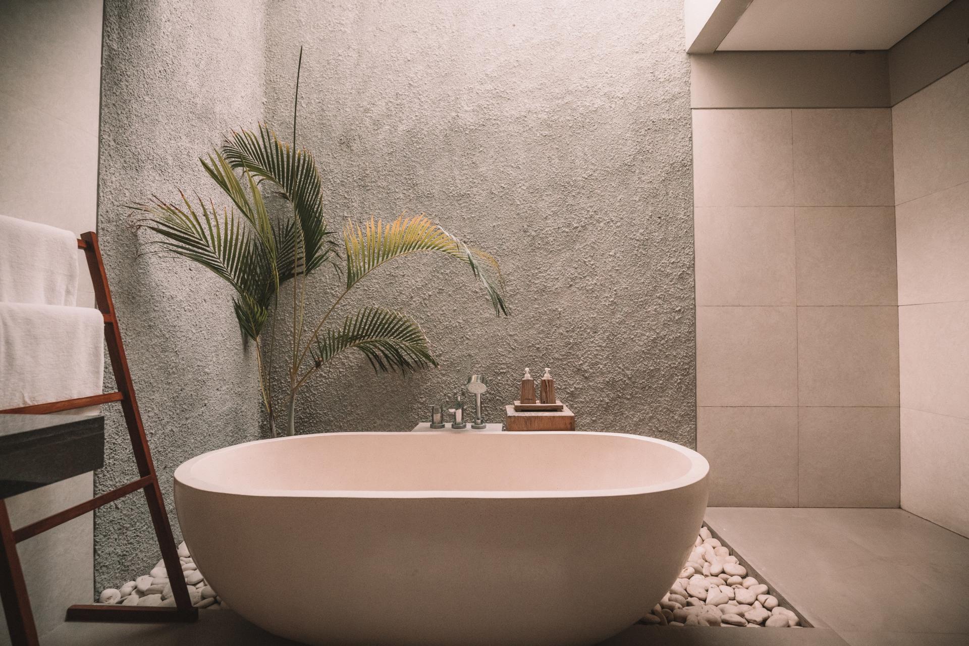 A bathroom with a bathtub and a towel rack.