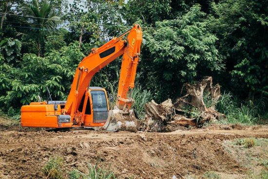 earth moving machine clearing a soil